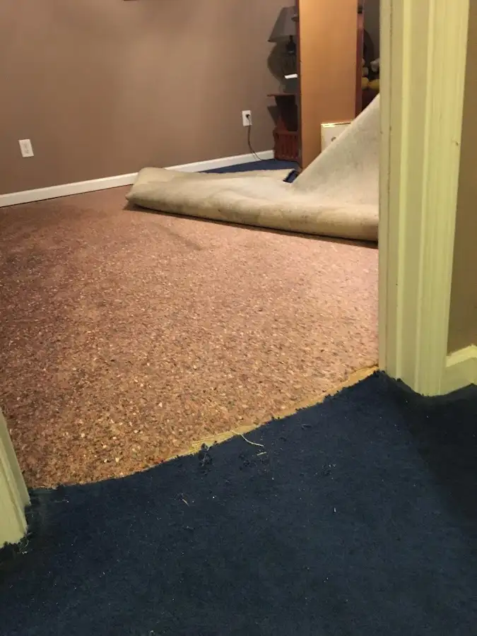 Carpet pad removal revealing water damage during Drying & Dehumidification in Grambling